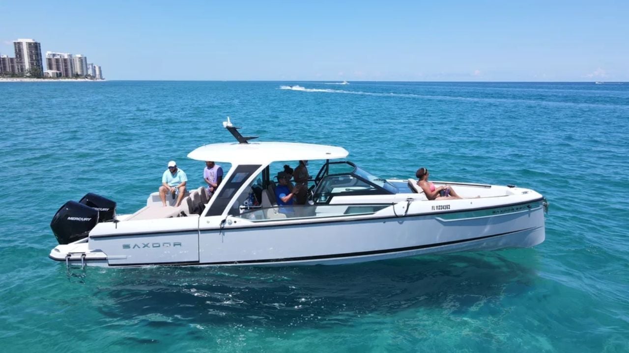 Motorboat Saxdor cruising turquoise water with passengers relaxing.